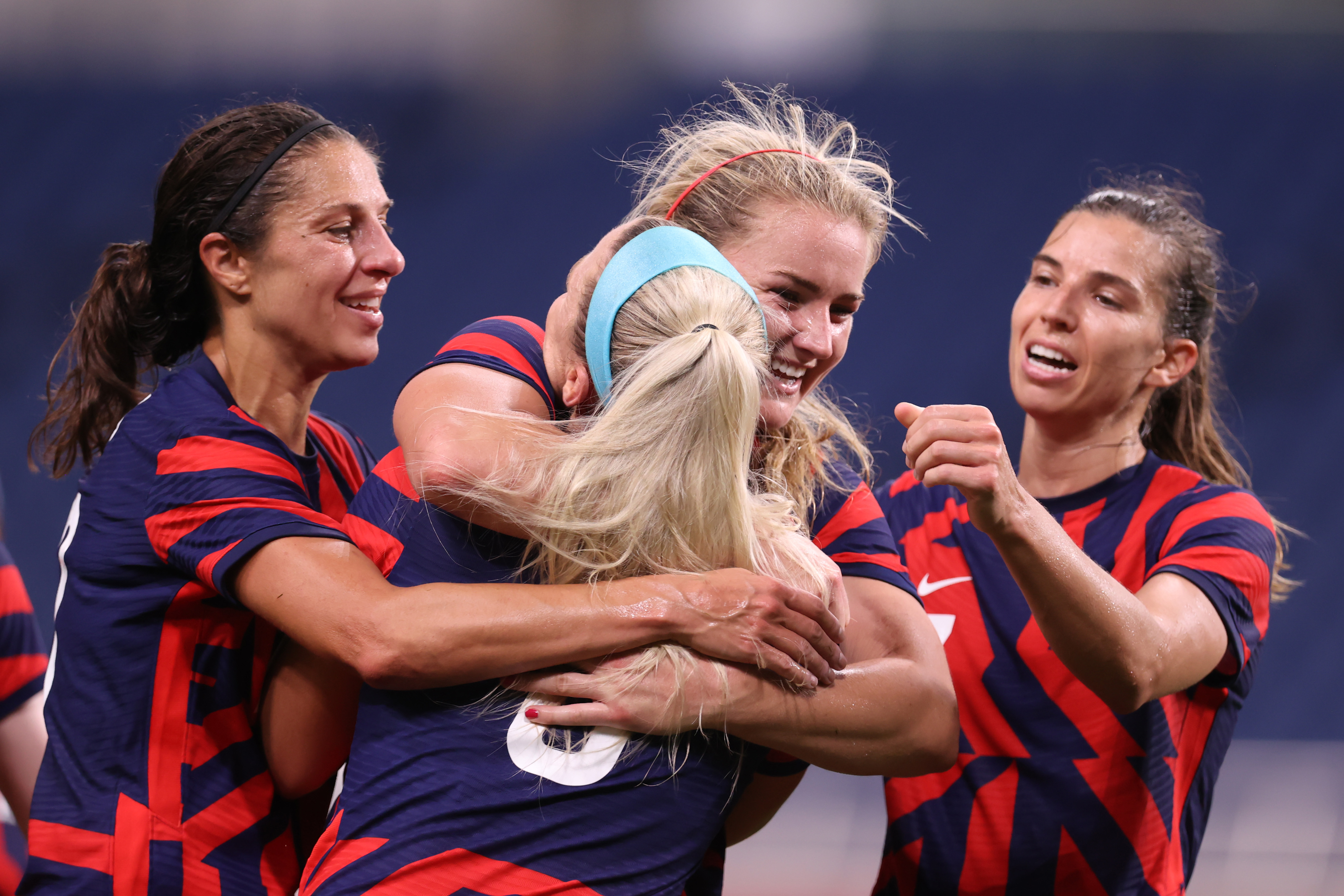 SAITAMA, JAPAN - JULY 24: Lindsey Horan #9 of Team United States celebrates with team mates after scoring their side's second goal during the Women's First Round Group G match between New Zealand and United States on day one of the Tokyo 2020 Olympic Games at Saitama Stadium on July 24, 2021 in Saitama, Japan. (Photo by Alex Grimm - FIFA/FIFA via Getty Images)