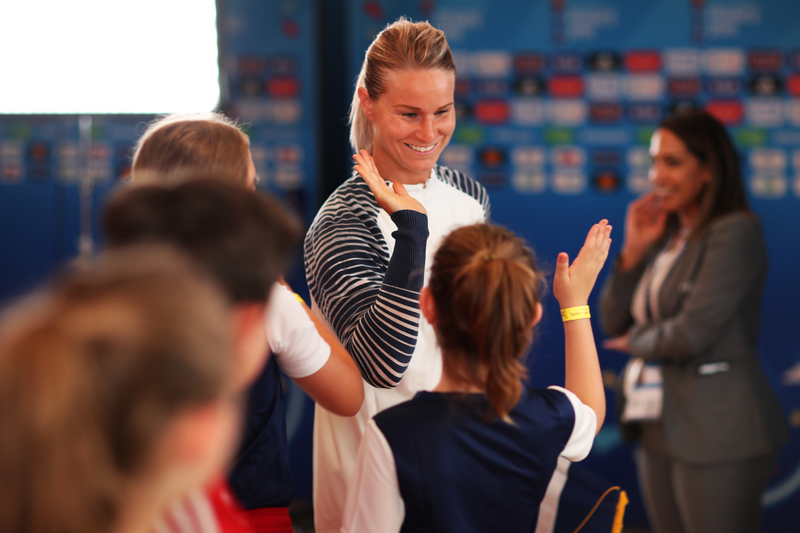 Amandine Henry of France high fives mascots in the tunnel 