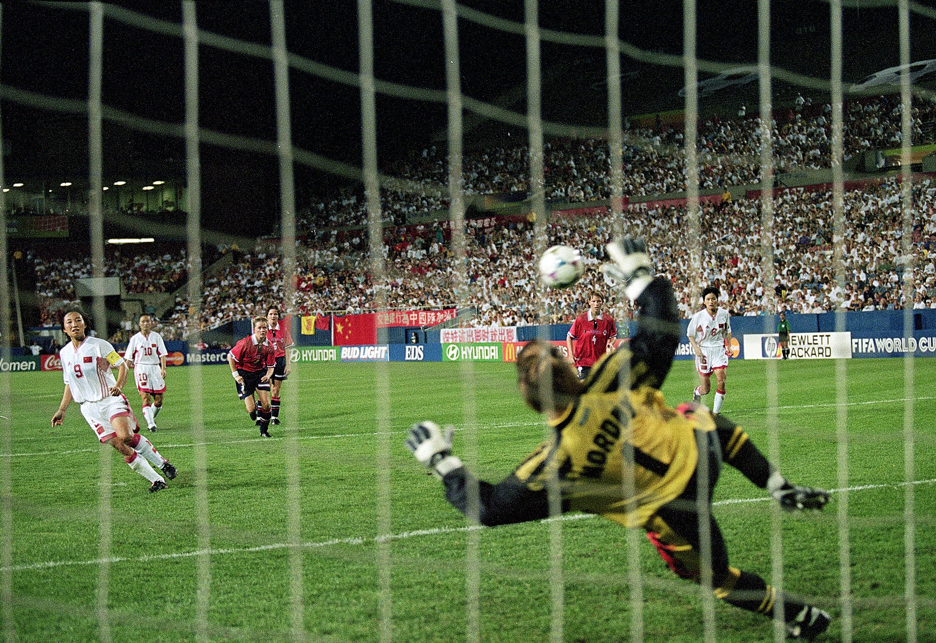 4 Jul 1999: Wen Sun #9 of Team China shoots to score a goal on Bente Nordby #1 of Team Norway during the Womens World Cup Game at the Foxboro Stadium in Foxboro, Massachusetts. Team China defeated Team Norway 5-0. Mandatory Credit: Jamie Squire  /Allsport