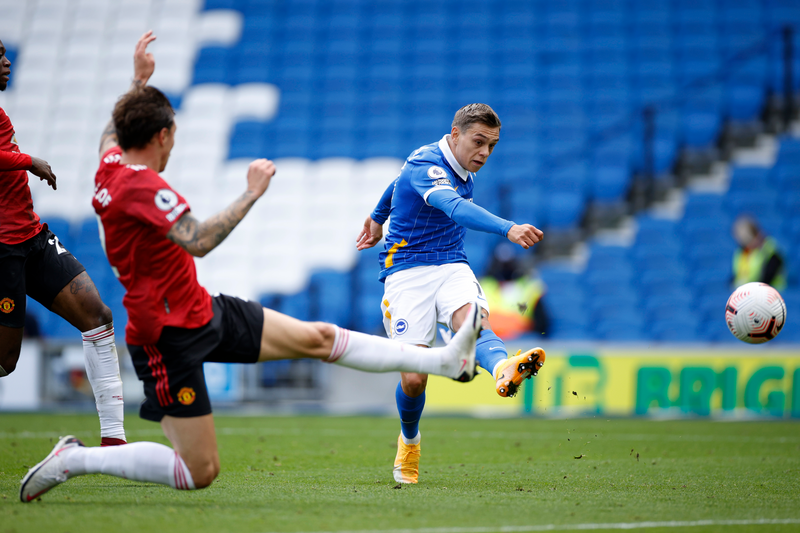 Leandro Trossard of Brighton and Hove Albion is challenged by Victor Lindelof of Manchester United