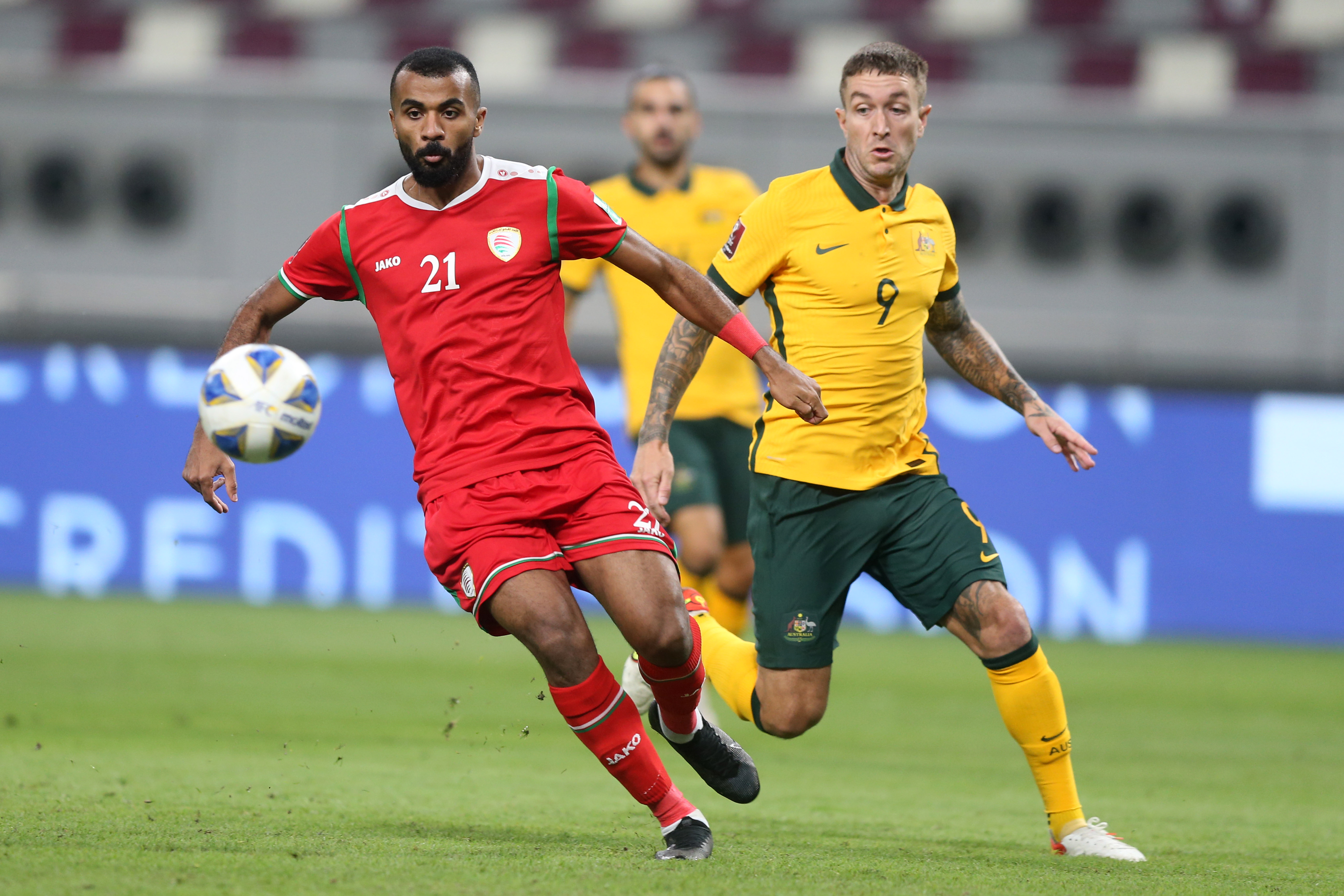 DOHA, QATAR - OCTOBER 07: Adam Taggart (R) of Australia and Abdulaziz Al Gheilani of Oman battle for the ball during the 2022 FIFA World Cup Qualifier match between Australia and Oman at Khalifa International Stadium on October 7, 2021 in Doha, Qatar. (Photo by Mohamed Farag/Getty Images)