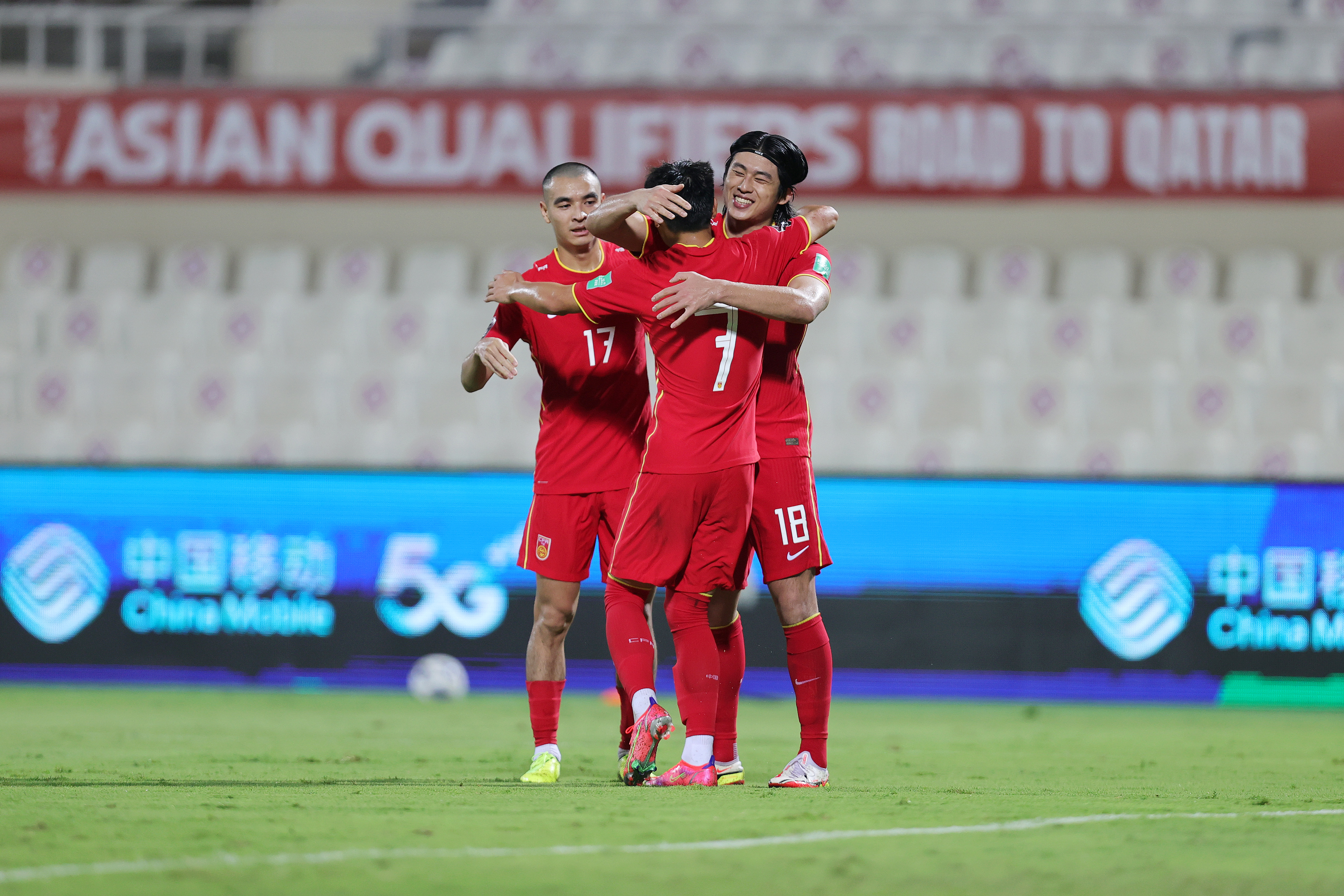 SHARJAH, UNITED ARAB EMIRATES - OCTOBER 07: Yuning Zhang of China PR celebrates with teammates Lei Wu and Binbin Liu after scoring the first goal during the FIFA World Cup Asian Qualifier final round Group B match between China and Vietnam at Sharjah Stadium on October 07, 2021 in Sharjah, United Arab Emirates. (Photo by Christopher Pike/Getty Images)