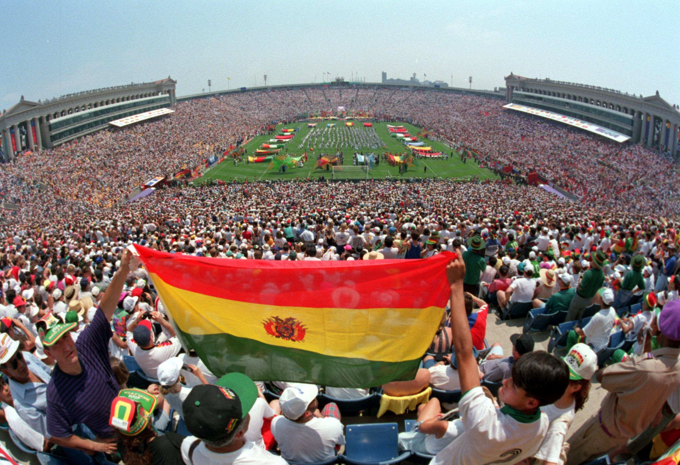 BOLIVIAN FANS HOLD UP THEIR NATIONAL FLAG