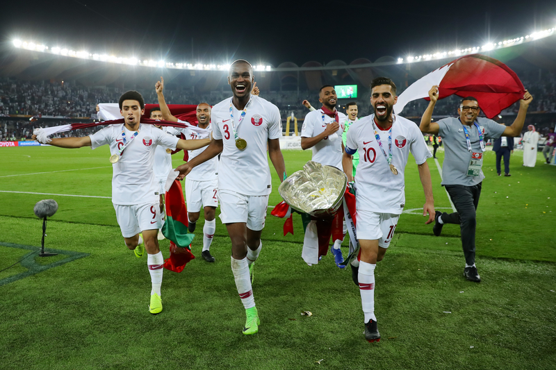 ABU DHABI, UNITED ARAB EMIRATES - FEBRUARY 01: Khaled Mohammed, Abdelkarim Hassan and Hasan Al Haydos of Qatar celebrate with the AFC Asian Trophy following their sides victory in the AFC Asian Cup final match between Japan and Qatar at Zayed Sports City Stadium on February 01, 2019 in Abu Dhabi, United Arab Emirates. (Photo by Francois Nel/Getty Images)