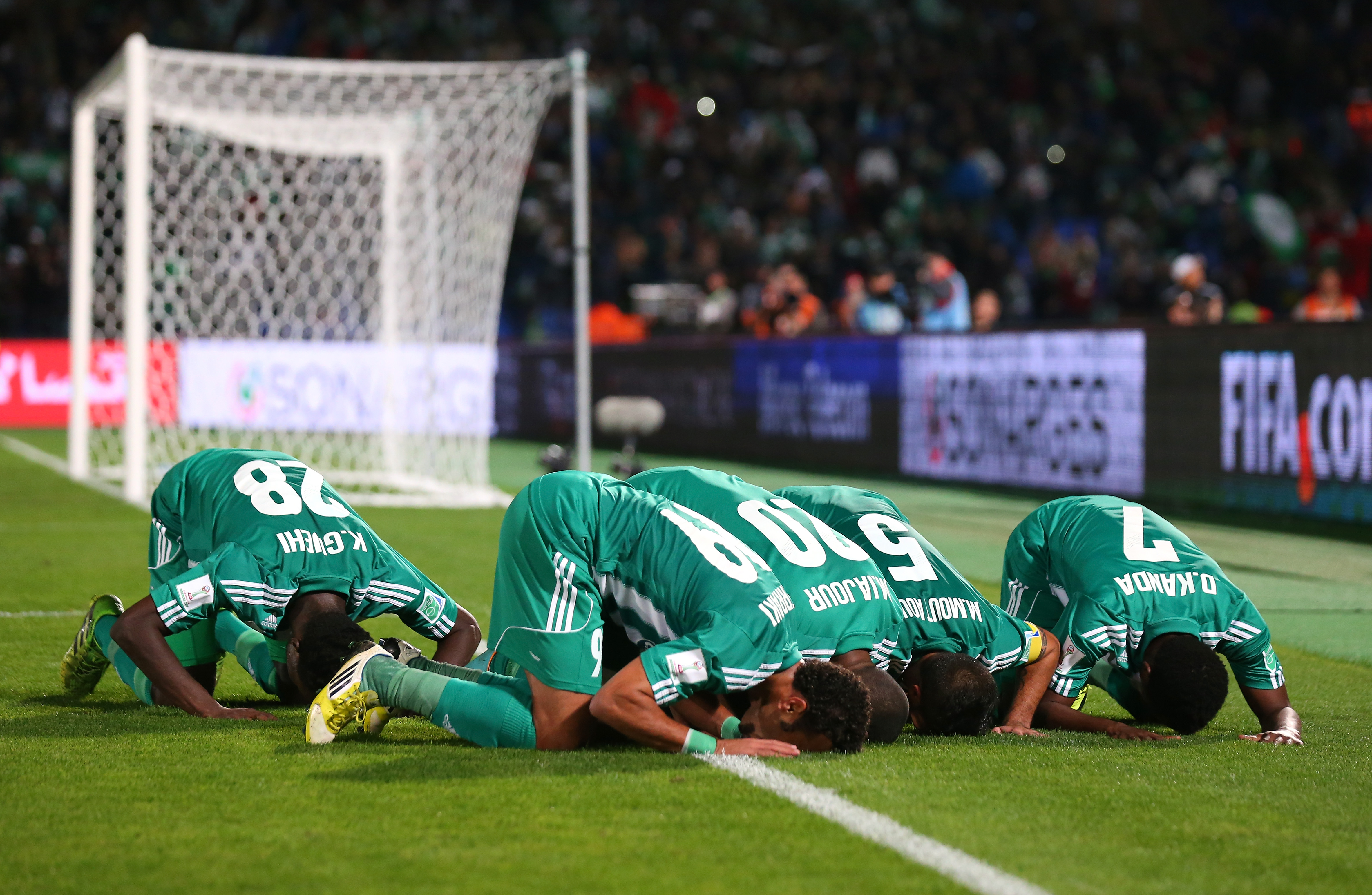 MARRAKECH, MOROCCO - DECEMBER 18:  Mohsine Moutaouali of Raja Casablanca celebrates with team mates after scoring from the penalty spot during the FIFA Club World Cup Semi Final match between Raja Casablanca and Atletico Mineiro at the Marrakech Stadium on December 18, 2013 in Marrakech, Morocco.  (Photo by Alex Livesey - FIFA/FIFA via Getty Images)