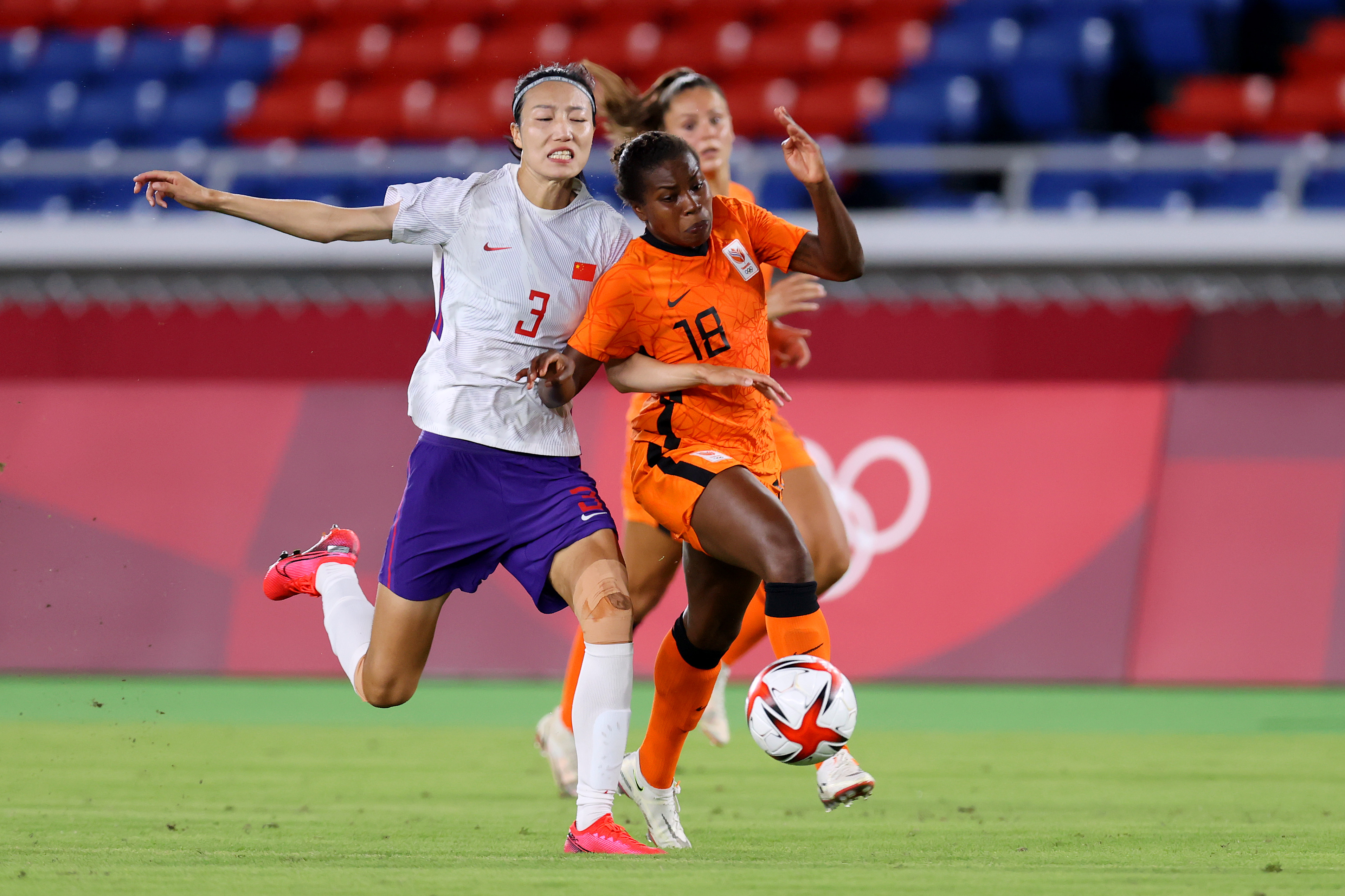 YOKOHAMA, JAPAN - JULY 27: Lineth Beerensteyn #18 of Team Netherlands looks to get away from Yuping Lin #3 of Team China during the Women's Group F match between Netherlands and China during the Tokyo 2020 Olympic Games at International Stadium Yokohama on July 27, 2021 in Yokohama, Tokyo, Japan. (Photo by Alex Grimm - FIFA/FIFA via Getty Images)