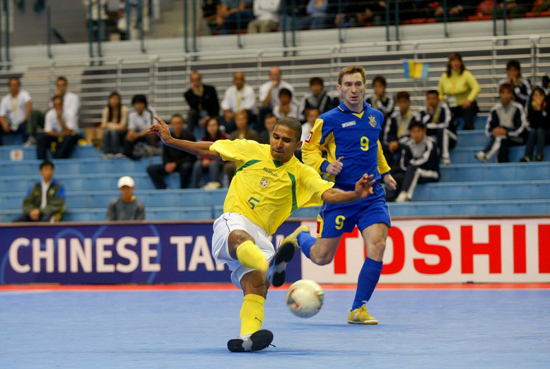 Football - FIFA Futsal World Championship Chinese Taipei 2004 - Group F - Brazil v Ukraine - National Taiwan University , Taipei City - 28/11/04.Actionshot , Manoel Tobias - Brazil shoots at goal against Ukraine , Host Nation board , Toshiba board.Mandatory credit: Action Images / Brandon Malone