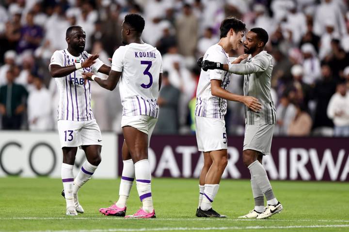 Ahmed Barman Ali shakes hands with Kouame Kouadio as Park Yong-Woo embraces Khalid Eisa of Al Ain as they celebrate 