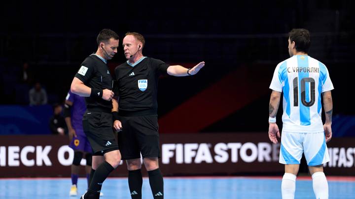 TASHKENT, UZBEKISTAN - SEPTEMBER 21: Referees Chris Sinclair and Antony Riley interact with Constantino Vaporaki of Argentina during the FIFA Futsal World Cup Uzbekistan 2024 match between Angola and Argentina at Humo Arena on September 21, 2024 in Tashkent, Uzbekistan. (Photo by Alex Caparros - FIFA/FIFA via Getty Images)