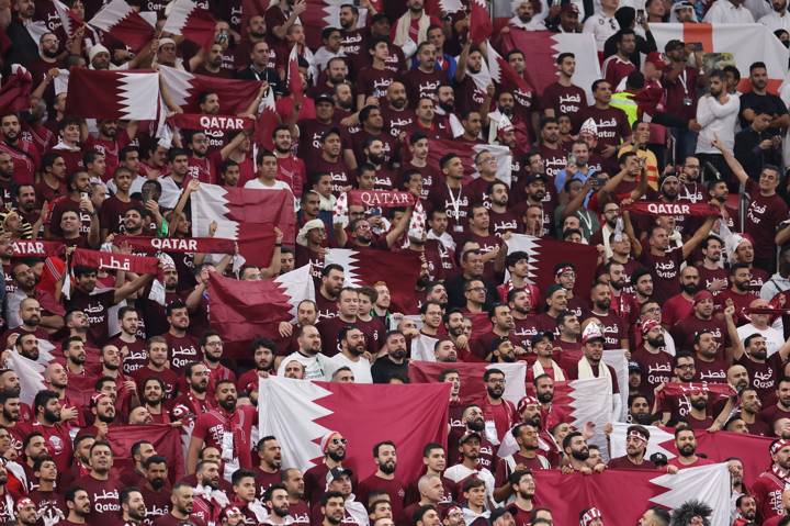 Qatar supporters wave national flags 