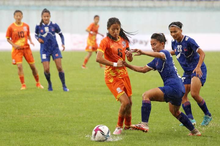 Bhutan midfielder Pema Choden Tshering # 6 in action in an international match against Nepal