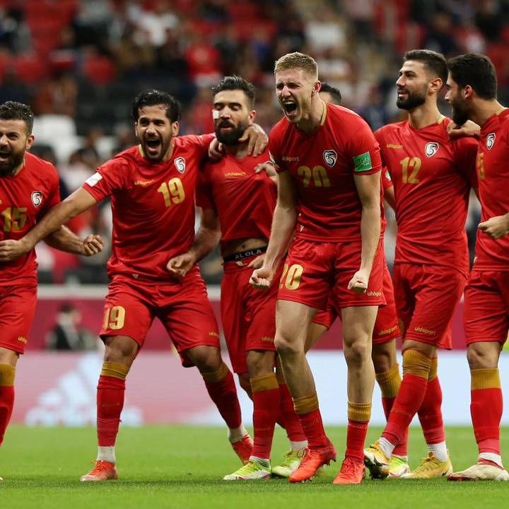 AL KHOR, QATAR - DECEMBER 03: Mohammad Anez of Syria celebrates with teammates Mohammed Sahyouni, Moaiad Alkhouli, Oliver Kass Kawo, Mohammed Osman and Yousef Mohamma after scoring their team's second goal during the FIFA Arab Cup Qatar 2021 Group B match between Syria and Tunisia at Al Bayt Stadium on December 03, 2021 in Al Khor, Qatar. (Photo by Cathrin Mueller - FIFA/FIFA via Getty Images)