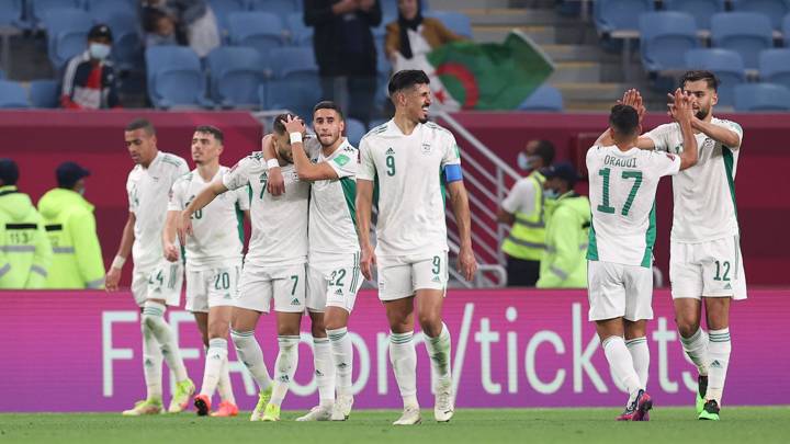 AL WAKRAH, QATAR - DECEMBER 04: Tayeb Meziani of Algeria (obscured) celebrates with teammates, embracing Zineddine Boutmene, after scoring their team's second goal during the FIFA Arab Cup Qatar 2021 Group D match between Lebanon and Algeria at Al Janoub Stadium on December 04, 2021 in Al Wakrah, Qatar. (Photo by Maddie Meyer - FIFA/FIFA via Getty Images)