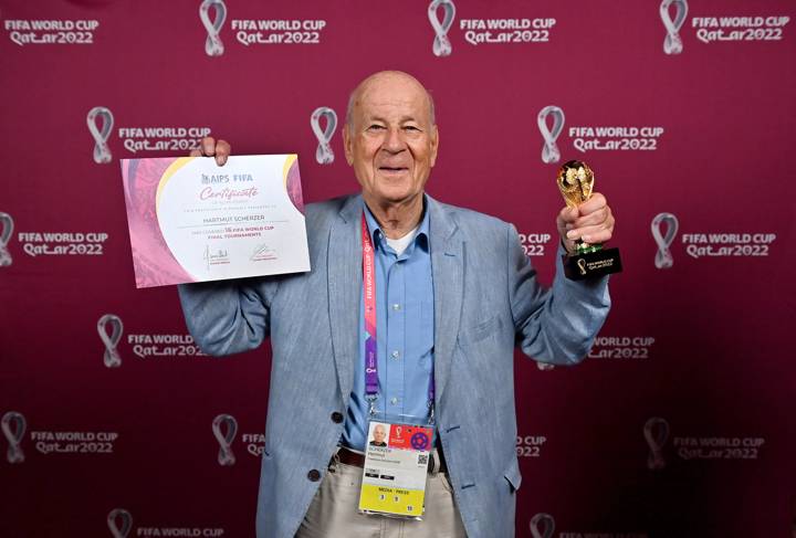 Hartmut Scherzer with a world cup replica trophy and certificate, in recognition of their achievement of covering 8 or more FIFA World Cup