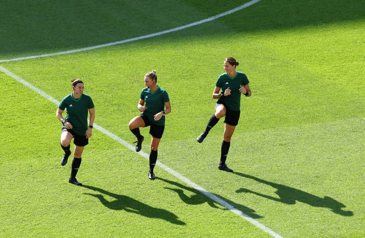 Referee Tori Penso and fellow officials warm up