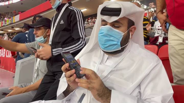 Faisal Al Kohaji enjoys audio descriptive commentary at Al Bayt Stadium during the FIFA Arab Cup. Image courtesy of the Qatar 2022 Supreme Committee.