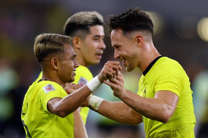 Darren Lok #9 of Malaysia celebrates with Faisal Halim #7