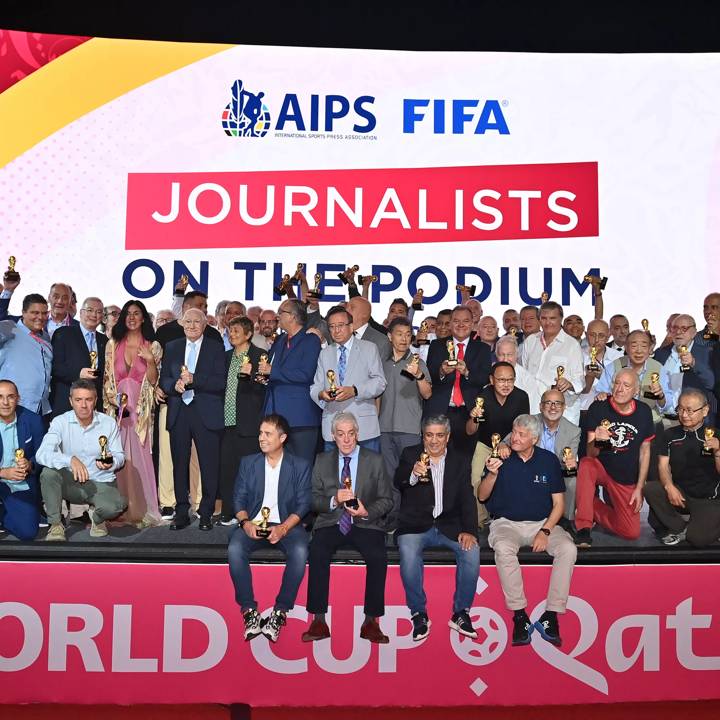 DOHA, QATAR - NOVEMBER 26: Journalists with their world cup replica trophies, in recognition of their achievement of covering 8 or more FIFA World Cups, during an AIPS / FIFA Journalist on the Podium ceremony at the Main Media Centre on November 29, 2022 in Doha, Qatar. (Photo by Brendan Moran/FIFA)