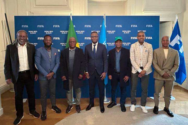 Benin Sport Minister Benoît M. K. Dato (C), FIFA Council Member Mathurin de Chacus, FIFA Member Associations Director Africa Gelson Fernandes and guests pose for a photo during a meeting at FIFA Paris Offices