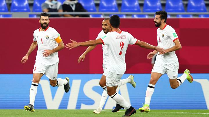 DOHA, QATAR - DECEMBER 07: Baha Suleiman of Jordan celebrates with teammates after scoring their team's first goal during the FIFA Arab Cup Qatar 2021 Group C match between Jordan and Palestine at Stadium 974 on December 07, 2021 in Doha, Qatar. (Photo by Francois Nel - FIFA/FIFA via Getty Images)