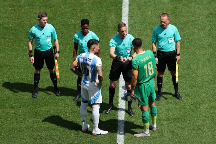 Nicolas Otamendi #16 of Team Argentina and Aymen Hussein #18 of Team Iraq stand for coin toss with Referee, Espen Eskas