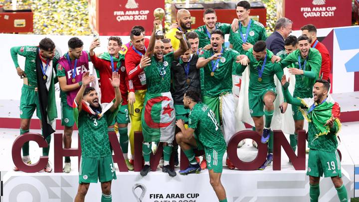 AL KHOR, QATAR - DECEMBER 18: Yacine Brahimi of Algeria celebrates with the FIFA Arab Cup trophy following victory during the FIFA Arab Cup Qatar 2021 Final match between Tunisia and Algeria at Al Bayt Stadium on December 18, 2021 in Al Khor, Qatar. (Photo by Maddie Meyer - FIFA/FIFA via Getty Images)