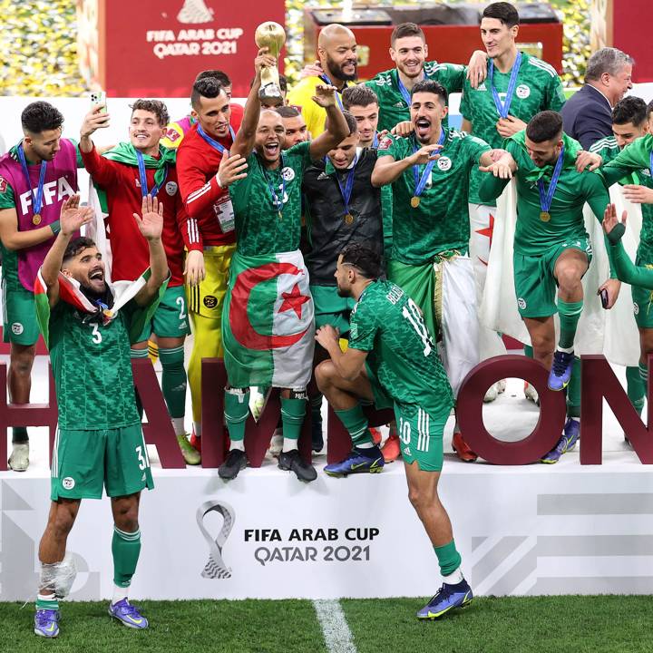 AL KHOR, QATAR - DECEMBER 18: Yacine Brahimi of Algeria celebrates with the FIFA Arab Cup trophy following victory during the FIFA Arab Cup Qatar 2021 Final match between Tunisia and Algeria at Al Bayt Stadium on December 18, 2021 in Al Khor, Qatar. (Photo by Maddie Meyer - FIFA/FIFA via Getty Images)