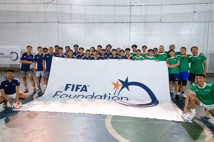 Children pose before an exhibition Futsal community match organised by the FIFA Foundation at Sampoerna Sports Club In Bandung, West Java 