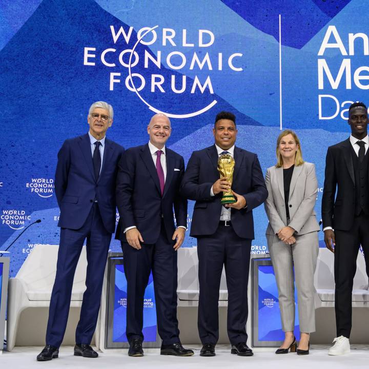 (L-R) FIFA global football development head Arsene Wenger, FIFA president Gianni Infantino, former Brazilian footballer Ronaldo holding the football World Cup trophy, former footballer and coach Jill Ellis, Chelsea goalkeeper Edouard Mendy and African Rainbow Mineral chairman Patrice Motsepe pose at the of their session during the World Economic Forum (WEF) annual meeting in Davos on May 23, 2022. (Photo by Fabrice COFFRINI / AFP) (Photo by FABRICE COFFRINI/AFP via Getty Images)