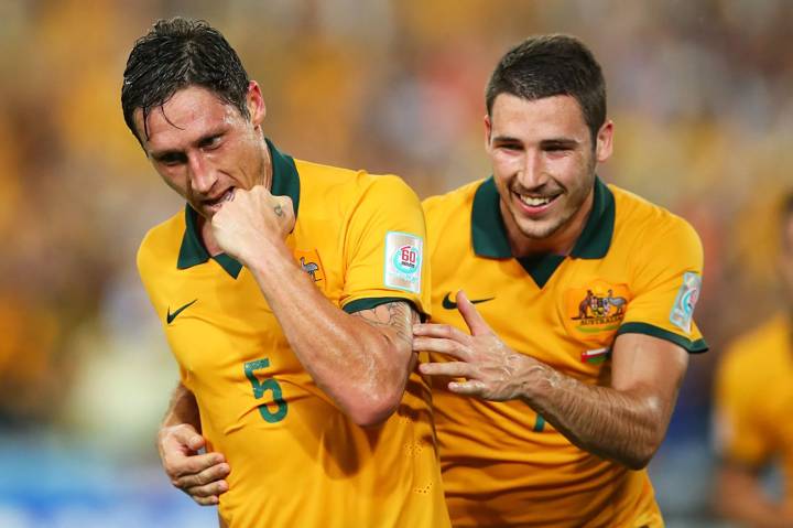 Mark Milligan of Australia celebrates with team mate Mathew Leckie after scoring a goal during the 2015 Asian Cup match between Oman and Australia at ANZ Stadium on January 13, 2015 in Sydney, Australia