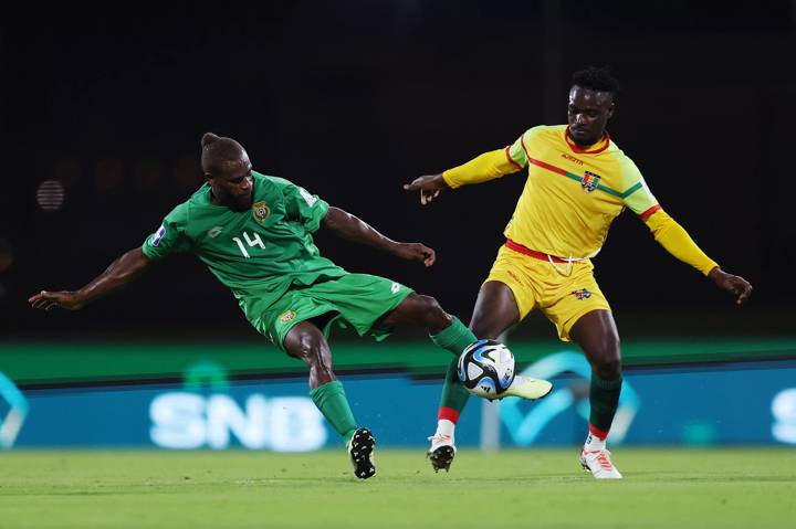 Kerry Iawak of Vanuatu and Balla Moussa Conte of Guinea battle for possession