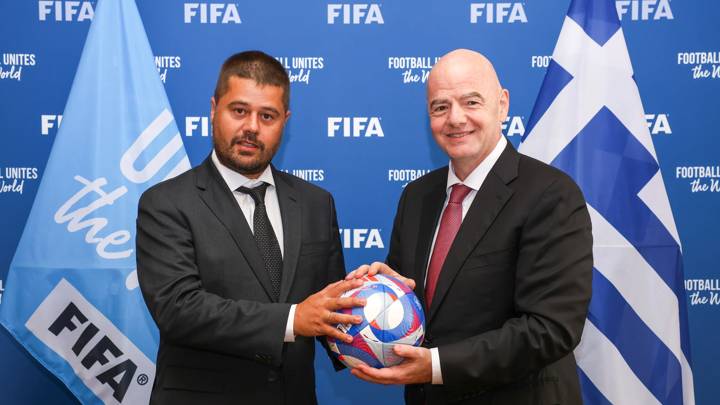 PARIS, FRANCE - JULY 31: FIFA President Gianni Infantino and Hellenic Football Federation President Chrysostomos Gkagkatsis pose with an Olympic Games Paris 2024 official match ball during a meeting between FIFA and the Hellenic Football Federation at FIFA's Paris office on July 31, 2024 in Paris, France. (Photo by Léo-Paul Ridet/FIFA)