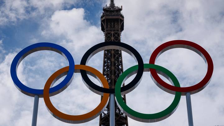 This photograph shows the Olympic Rings displayed at the construction site of the Eiffel Tower Stadium for the upcoming Paris 2024 Olympics and Paralympic Games which will host the Beach Volleyball and men's Blind Football competitions, at the Champ-De-Mars in Paris on July 10, 2024. The Champ de Mars and the Trocadero, located on either side of the Eiffel Tower, will host several events of the Paris Olympic and Paralympic Games, on July 10, 2024. (Photo by Dimitar DILKOFF / AFP) (Photo by DIMITAR DILKOFF/AFP via Getty Images)