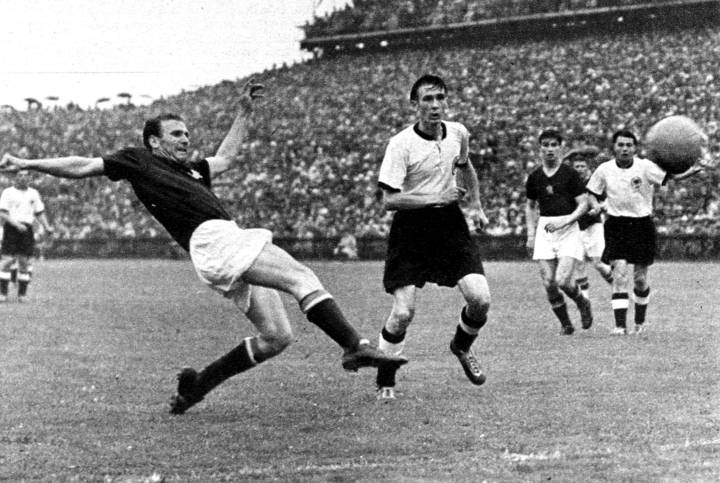 Hungary forward Nandor Hidegkuti fires in a shot as West Germany's Horst Eckel watches during the 1954 FIFA World Cup Final