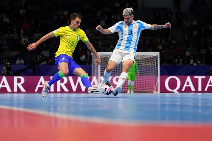 Marcel of Brazil and Angel Claudino of Argentina battle for possession