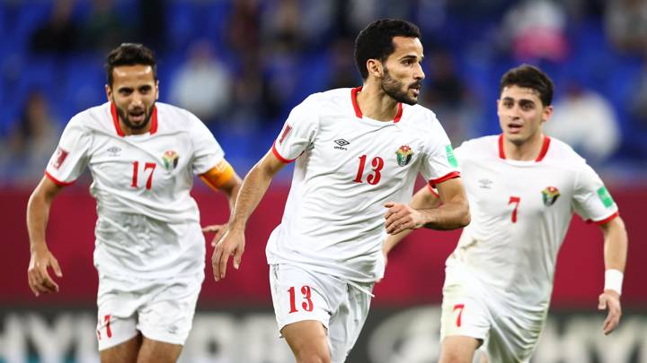 DOHA, QATAR - DECEMBER 07: Mahmoud Al Mardi of Jordan celebrates with teammates Rajai Ayed and Mohammad Abu Zraiq after scoring their team's third goal during the FIFA Arab Cup Qatar 2021 Group C match between Jordan and Palestine at Stadium 974 on December 07, 2021 in Doha, Qatar. (Photo by Francois Nel - FIFA/FIFA via Getty Images)