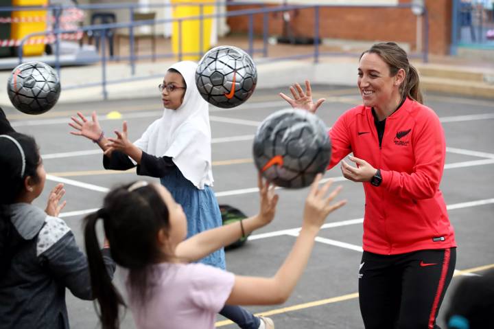 Football player Fern Annalie Longo participates in a skills coaching session with young children from the Mt Roskill Primary School during a New Zealand