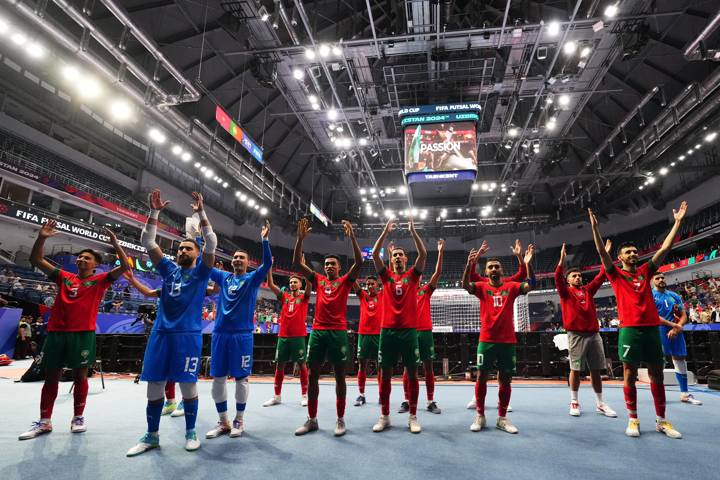 Players of Morocco applaud the fans