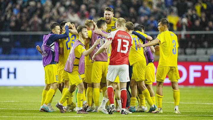 Players from Kasakhstan celebrates after winning the UEFA Euro 2024 Group H qualification football match Kasakhstan v Denmark next to Denmark's defender Victor Kristiansen in Astana, Kazakhstan on March 26, 2023. (Photo by Bo Amstrup / Ritzau Scanpix / AFP) / Denmark OUT (Photo by BO AMSTRUP/Ritzau Scanpix/AFP via Getty Images)