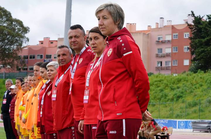 QUELUZ, PORTUGAL - MARCH 23: Katerina Mileska of North Macedonia with staff members and players during the National Anthem before the start of the UEFA Women's Under-17 Championship Estonia 2023 qualification match between Germany and North Macedonia on March 23, 2023 at Complexo Desportivo do Real Sport Clube in Queluz, Portugal. (Photo by Gualter Fatia/Getty Images for DFB)