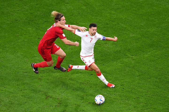 AL RAYYAN, QATAR - NOVEMBER 22: Youssef Msakni of Tunisia battles for possession with Joachim Andersen of Denmark during the FIFA World Cup Qatar 2022 Group D match between Denmark and Tunisia at Education City Stadium on November 22, 2022 in Al Rayyan, Qatar. (Photo by Laurence Griffiths/Getty Images)