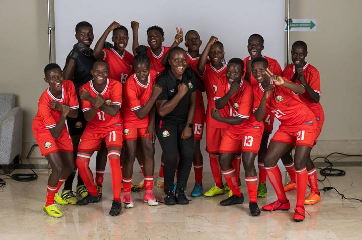 Mildred Cheche, Head Coach of Kenya, (C) poses for a portrait with her players 