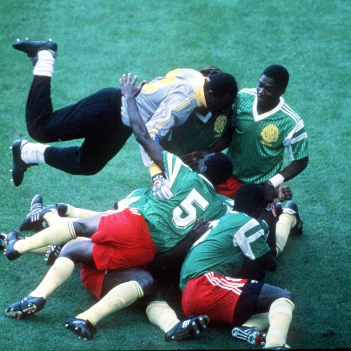 1990 World Cup Finals, Milan, Italy, 8th June, 1990, Argentina 0 v Cameroon 1, Cameroon players pile on top of each other as they celebrate the only goal scored by Omam Biyick  (Photo by Bob Thomas Sports Photography via Getty Images)