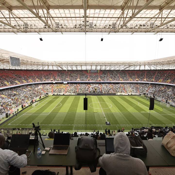 Spectators sit in the stands of the Stade de Senegal during its inauguration in Diamniadio, a town about 30 kilometres from the capital Dakar, on February 22, 2022. - Thousands of Senegalese gathered for the inauguration of a 50,000-seater stadium aimed at making the country Africa's go-to venue for international events. The venue, for now called the Stade de Senegal, will be the only one in Senegal that will be certified for international football. (Photo by SEYLLOU / AFP) (Photo by SEYLLOU/AFP via Getty Images)