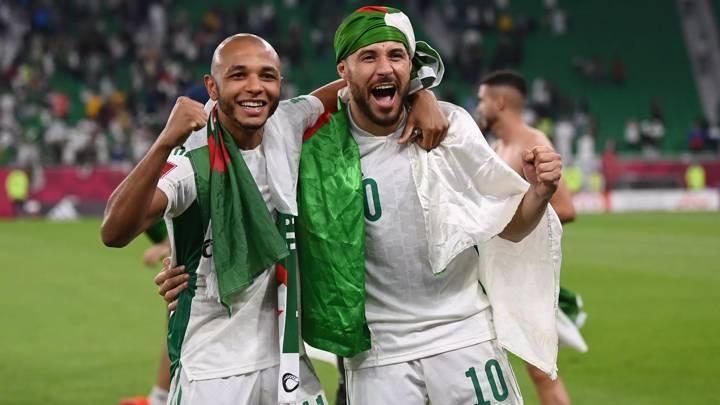 DOHA, QATAR - DECEMBER 11: Yacine Brahimi and Mohammed Belaili of Algeria celebrate victory in the FIFA Arab Cup Qatar 2021 Quarter-Final match between Morocco and Algeria at Al Thumana Stadium on December 11, 2021 in Doha, Qatar. (Photo by Michael Regan - FIFA/FIFA via Getty Images)