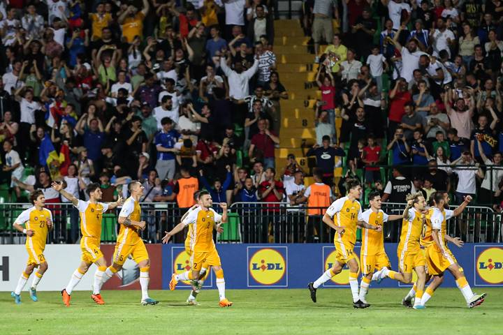 Moldavian players celebrate their team's third goal against Poland 