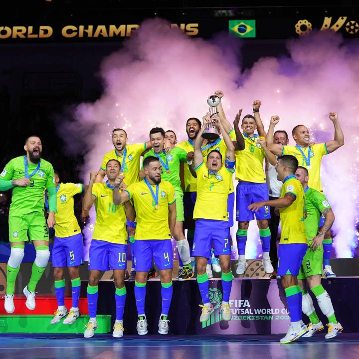 TASHKENT, UZBEKISTAN - OCTOBER 06: Players of Brazil celebrate victory as they lift the trophy following the FIFA Futsal World Cup Uzbekistan 2024 Final between Brazil and Argentina at Humo Arena on October 06, 2024 in Tashkent, Uzbekistan. (Photo by Alex Caparros - FIFA/FIFA via Getty Images)