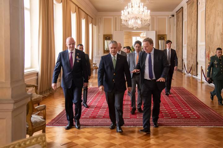 Colombia President Iván Duque Márquez (C) walks with FIFA President Gianni Infantino (L) after being awarded the Order of Boyacá with and FIFA Council Member Ramon Jesurun (R) 