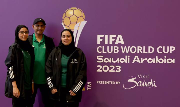 Volunteer Nader poses for a pictures with his daughters Sara and Yara 