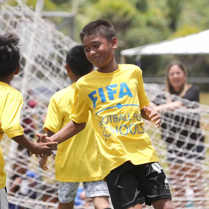 HARMON, GUAM – MAY 07: Talofofo Elementary School students celebrate a goal against the Bishop Baumgartner Memorial Catholic School during the FIFA Football 4 Schools Festival Jamboree at the Guam Football Association National Training Center on May 7, 2022 in Harmon, Guam. (Photo by Jill Espiritu/Guam Football Association)